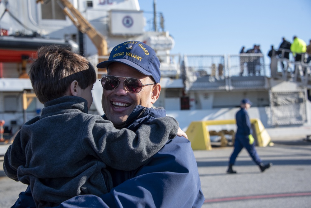 A Coast Guard Cutter Valiant crew member embraces his son Feb. 27, 2020, as he returns home to Naval Station Mayport, Florida. The Valiant crew returned home after completing a nine-week patrol in the Caribbean Sea supporting Joint Interagency Task Force South. (U.S. Coast Guard photo by Petty Officer 2nd Class Ryan Dickinson) 