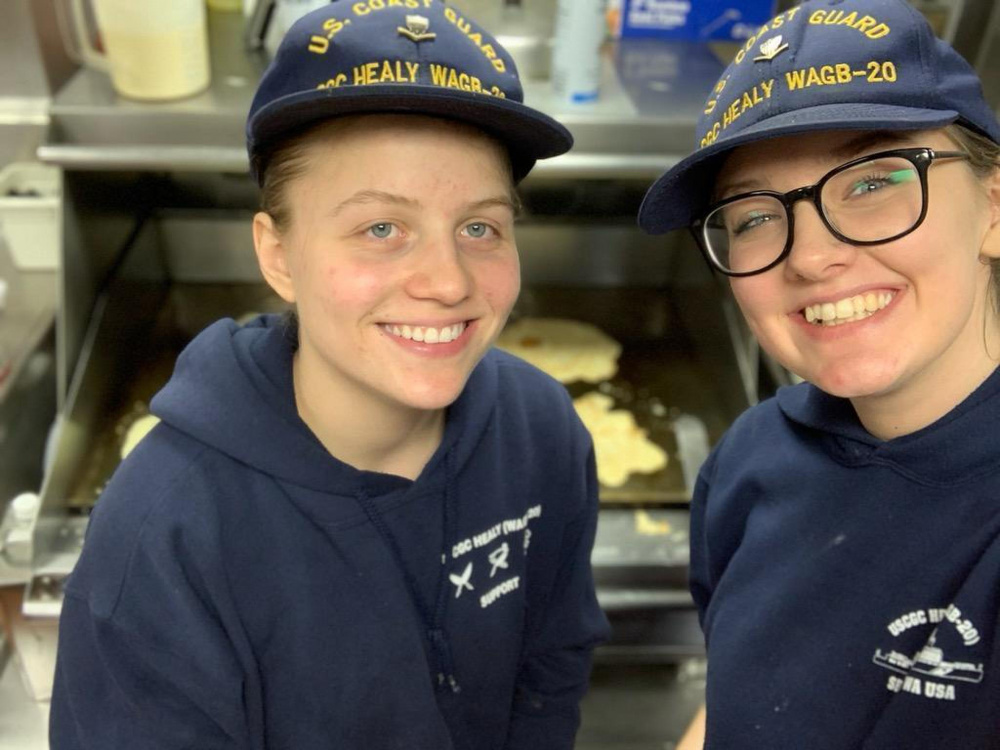 CS3 Regan Collins (left) and CS3 Katherine Blanch take a picture together in the kitchen onboard the CGC HEALY (U.S. Coast Guard Photo).
