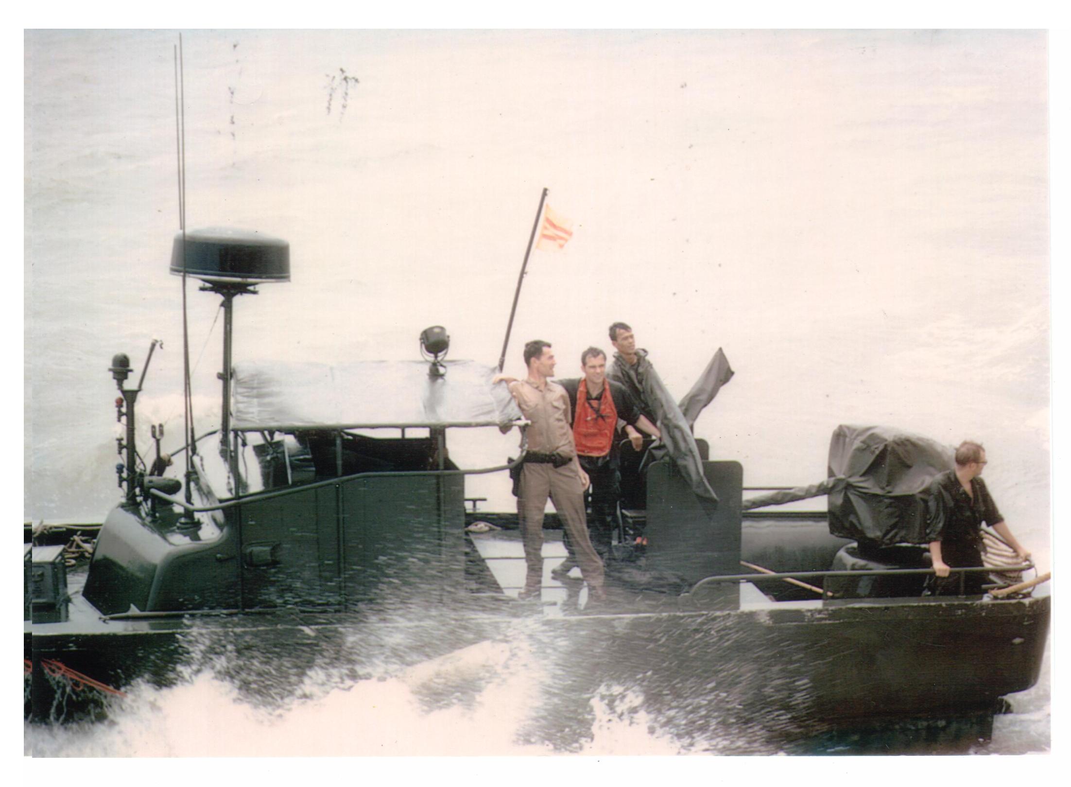 2.	Chief Hospital Corpsman Joseph “Doc” White catches a ride on a U.S. Navy patrol boat. (Mrs. Misa White)