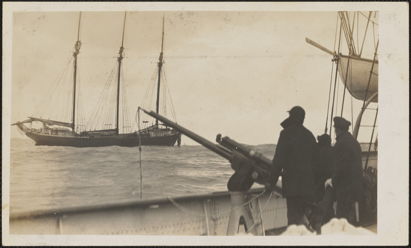 Cutter Manning prepares to shoot a messenger line to a disabled three-masted schooner. The messenger line was used to haul a heavy towing hawser from the cutter to the disabled vessel. (digitalcommonwealth.org)