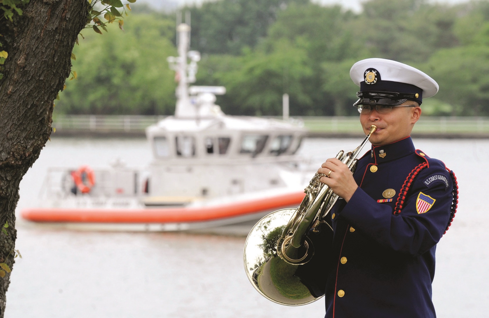 The copyright and licenses of “Semper Paratus” are held by three separate companies, and the U.S. Coast Guard Band pays $175 for the privilege to record it. A U.S. Coast Guard Band member warms up as a boat patrols the Potomac River near Fort Lesley McNair in Washington, D.C., May 25, 2010. (DoD photo by Cherie Cullen)