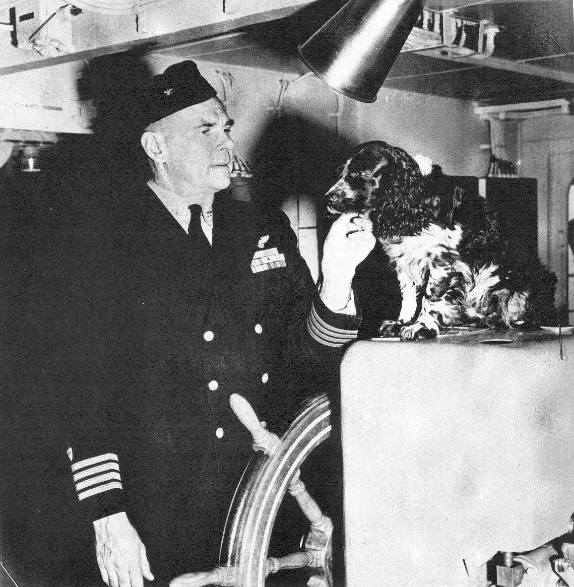 Capt. Carl Christian von Paulsen and one of his pet canines. This photo shows von Paulsen on the bridge of an attack transport with cocker spaniel “Eight Ball.” von Paulsen’s previous pet, a white bulldog named “Boy-o-boy,” had been a particular favorite with the Inuit people of Greenland. (U.S. Coast Guard)