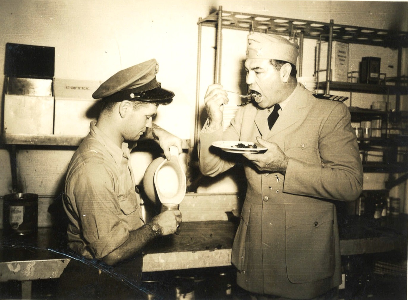 Chief Commissaryman Robert Manges serving former heavyweight boxing champ and Coast Guard commander, Jack Dempsey, pie and milk during Dempsey’s crossing to the European theater. (Courtesy of Robert Manges)
