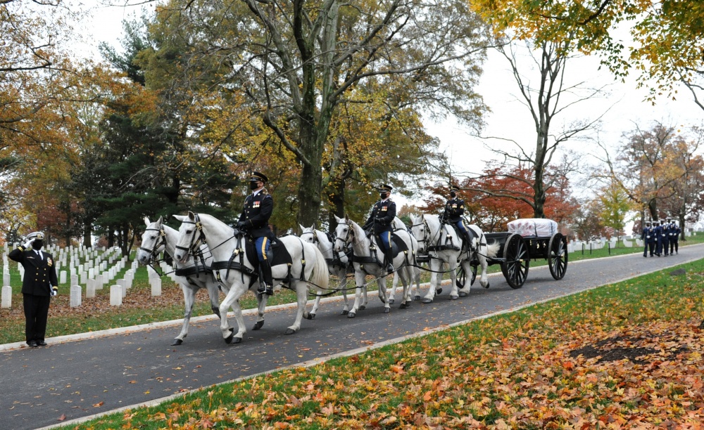 Six horses pull a black artillery caisson on which sits a flag-draped casket containing the remains of U.S. Coast Guard Captain Eleanor L'Ecuyer in Arlington National Cemetery, Virginia, Nov. 12, 2020. L'Ecuyer was the first direct commissioned female officer in the Coast Guard. (U.S. Coast Guard Photo by Petty Officer 2nd Class Brian McCrum) 