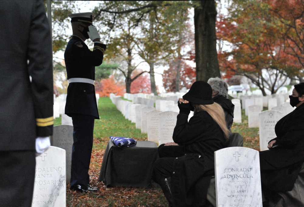 The Commanding Officer of the U.S. Coast Guard Ceremonial Honor Guard salutes the burial flag of Coast Guard Capt. Eleanor L'Ecuyer and delivers it to her family, Arlington National Cemetery, Virginia, Nov. 12, 2020. L'Ecuyer served her country from 1944 until 1971 and was the first direct-commissioned female officer in the Coast Guard. (U.S. Coast Guard Photo by Petty Officer 2nd Class Brian McCrum) 