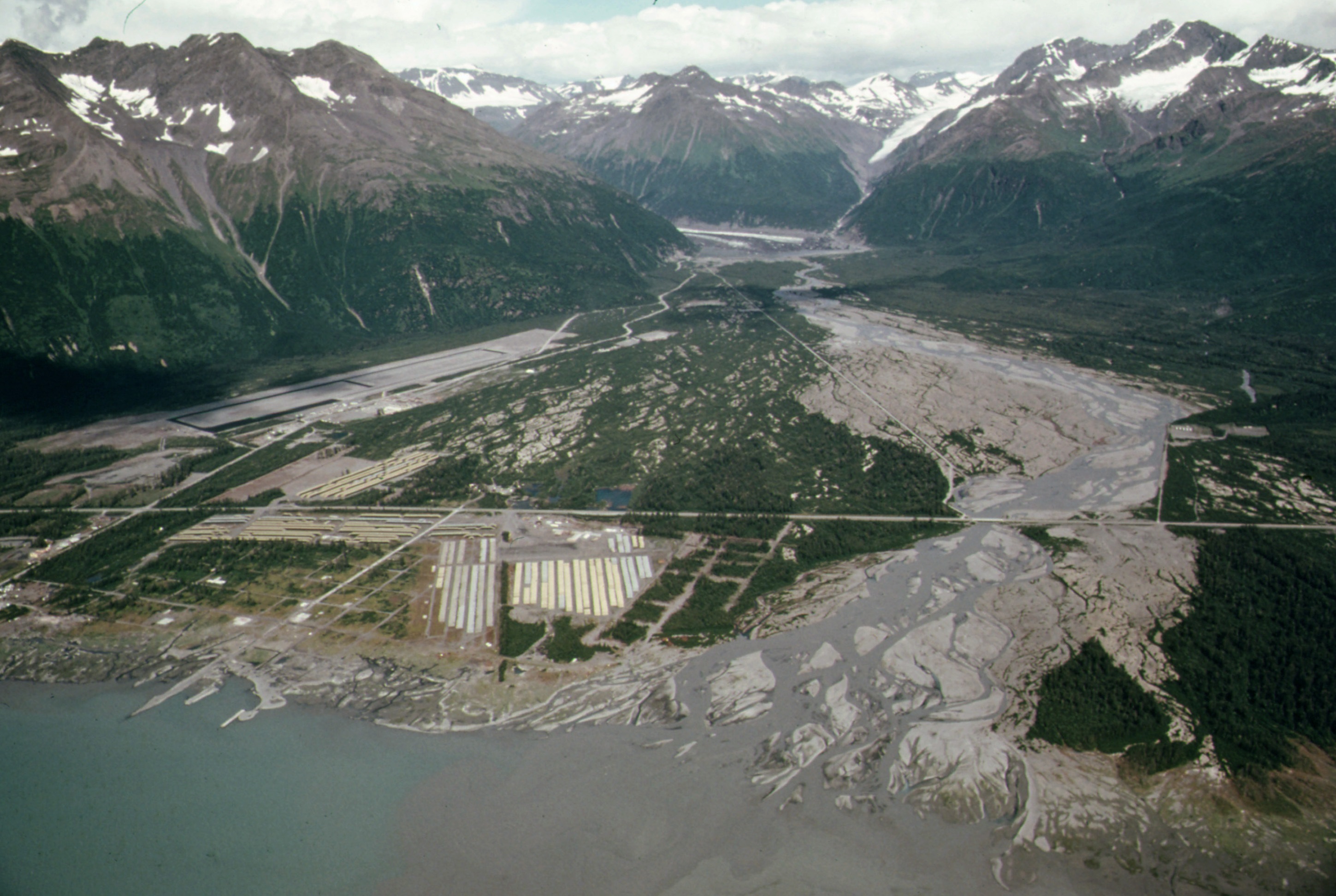 13.	An aerial view of the old township of Valdez. The community was moved to a new location after the devastating earthquake and tsunami. (Wikipedia)
