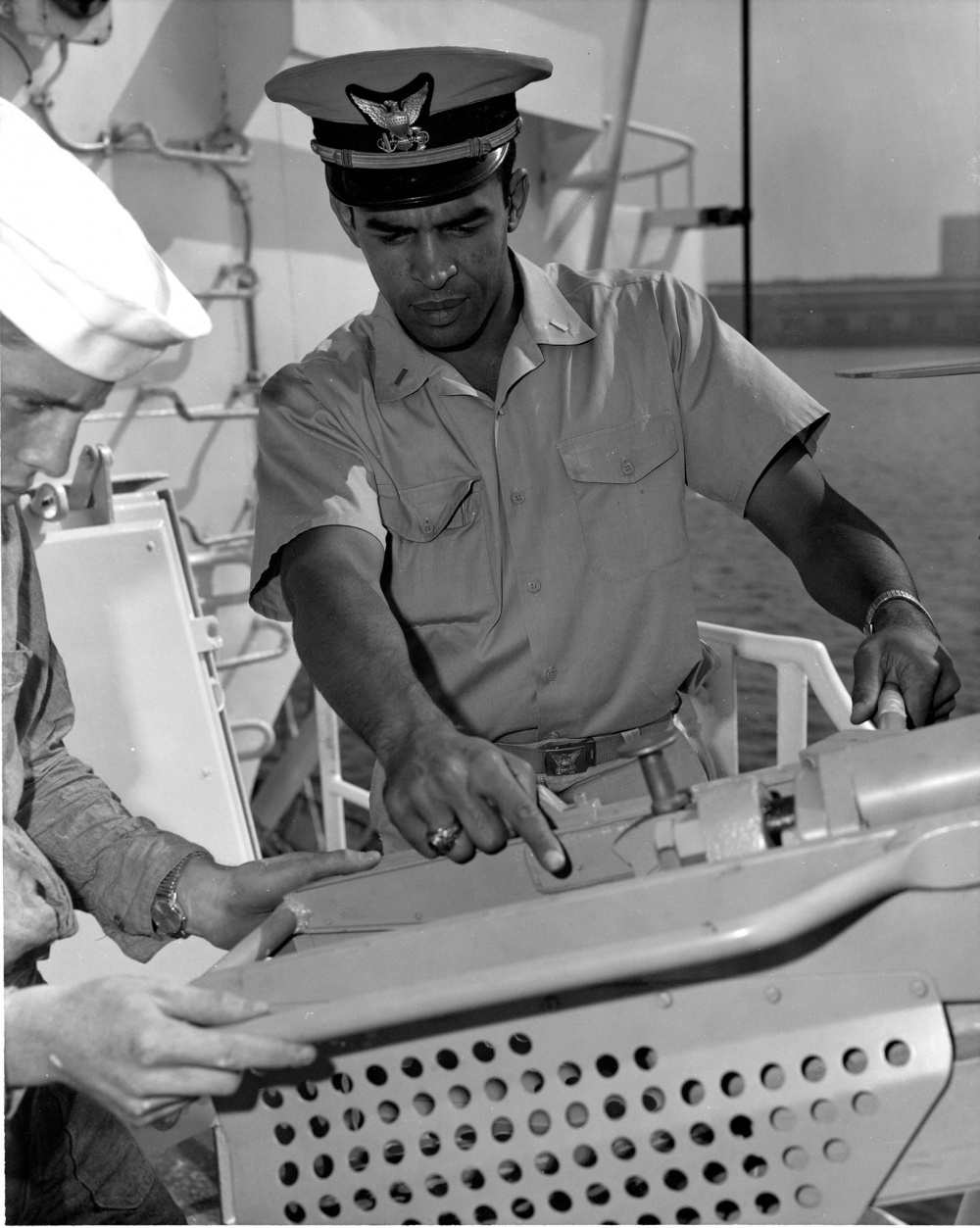 Cmdr. Merle J. Smith, Jr. was the second African American to receive an appointment to the U.S. Coast Guard Academy and the first to graduate. Smith examines the deck gun on an 82-foot Point Class cutter. (U.S. Coast Guard courtesy photo)