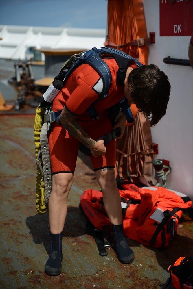 Seaman Kristine Kearny, a crewmember aboard the Coast Guard Cutter Sherman, dons a harness in preparation for surface swimmer training Jan. 12, 2017. Sherman, homeported in Honolulu, Sherman, homeported in Honolulu, has a number of surface swimmers aboard, and each one is required to enter the water, swim 25 yards, rescue the cutter’s Oscar by conducting a buddy tow to the cutter’s small boat, and swim back to the cuter. (U.S. Coast Guard photo by Chief Warrant Officer Allyson E.T. Conroy)