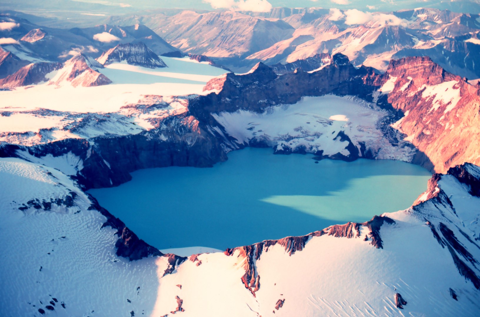 18.	A 1980 aerial photograph showing the caldera of Katmai Volcano where the mountaintop once stood. (NOAA)