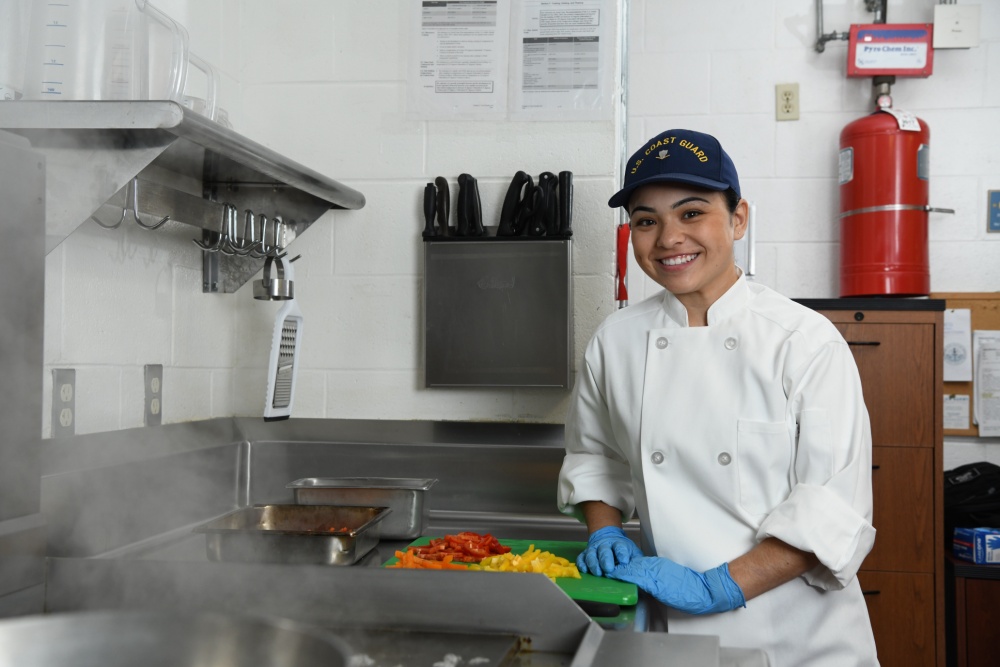 Petty Officer 3rd Class Samantha Waialae, a culinary specialist, poses for an environmental portrait in the galley of Coast Guard Station Cape Charles in Cape Charles, Virginia, March 21, 2019. Culinary specialist is one of four critical ratings for Coast Guard recruiting efforts. U.S. Coast Guard photo by Matt Sprague.