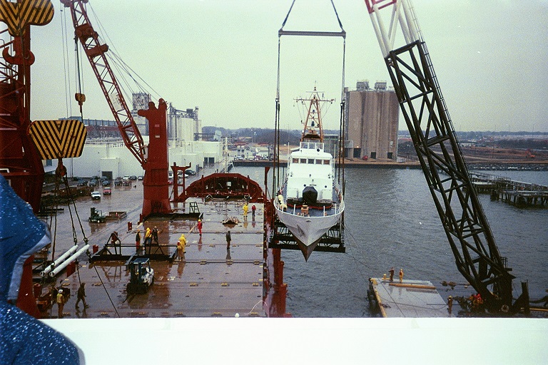 Heavy-lift crane loading110-foot patrol Cutter Adak onto Motor Vessel Industrial Challenger in Portsmouth, Virginia. (U.S. Coast Guard)