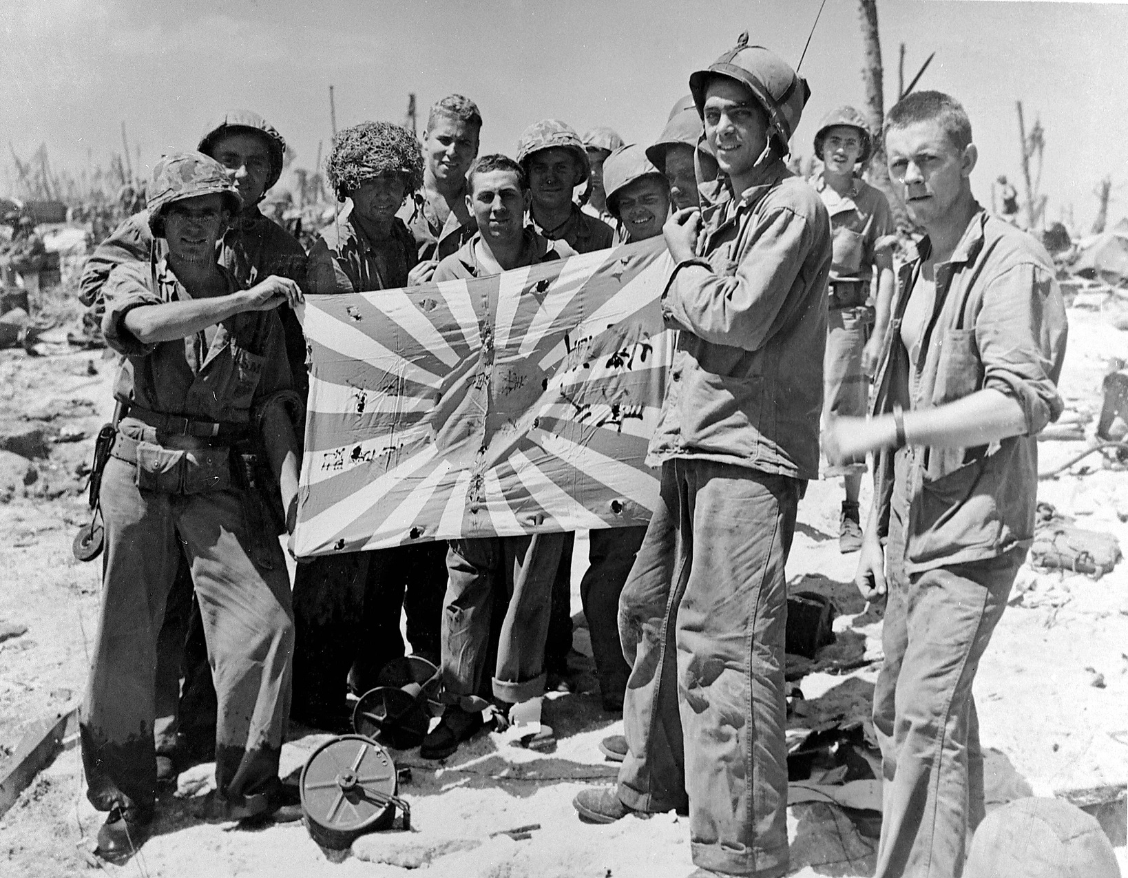 Marines and Coast Guardsmen with the Japanese flag now in the heritage collection of the US Coast Guard.  Engebi Island, Eniwetok Atoll, 19 February 1944. (National Archives Photo 80-G-216033).