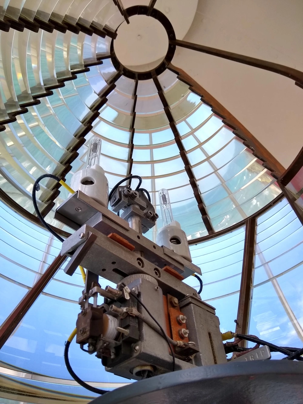 Aids to Navigation Team Honolulu maintains the light that shines through the third-order Fresnel lens at the Diamond Head Lighthouse. U.S. Coast Guard photo by Chief Petty Officer Joshua D. Williams.