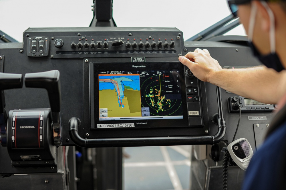 Petty Officer 2nd Class David Forrest explains how the 29-foot response boat computer system works while training in the Chesapeake Bay, Aug. 7, 2020. Boat crews get underway as often as possible to maintain qualifications and patrol their areas of responsibility. U.S. Coast Guard photo by Petty Officer 1st Class Dustin Williams