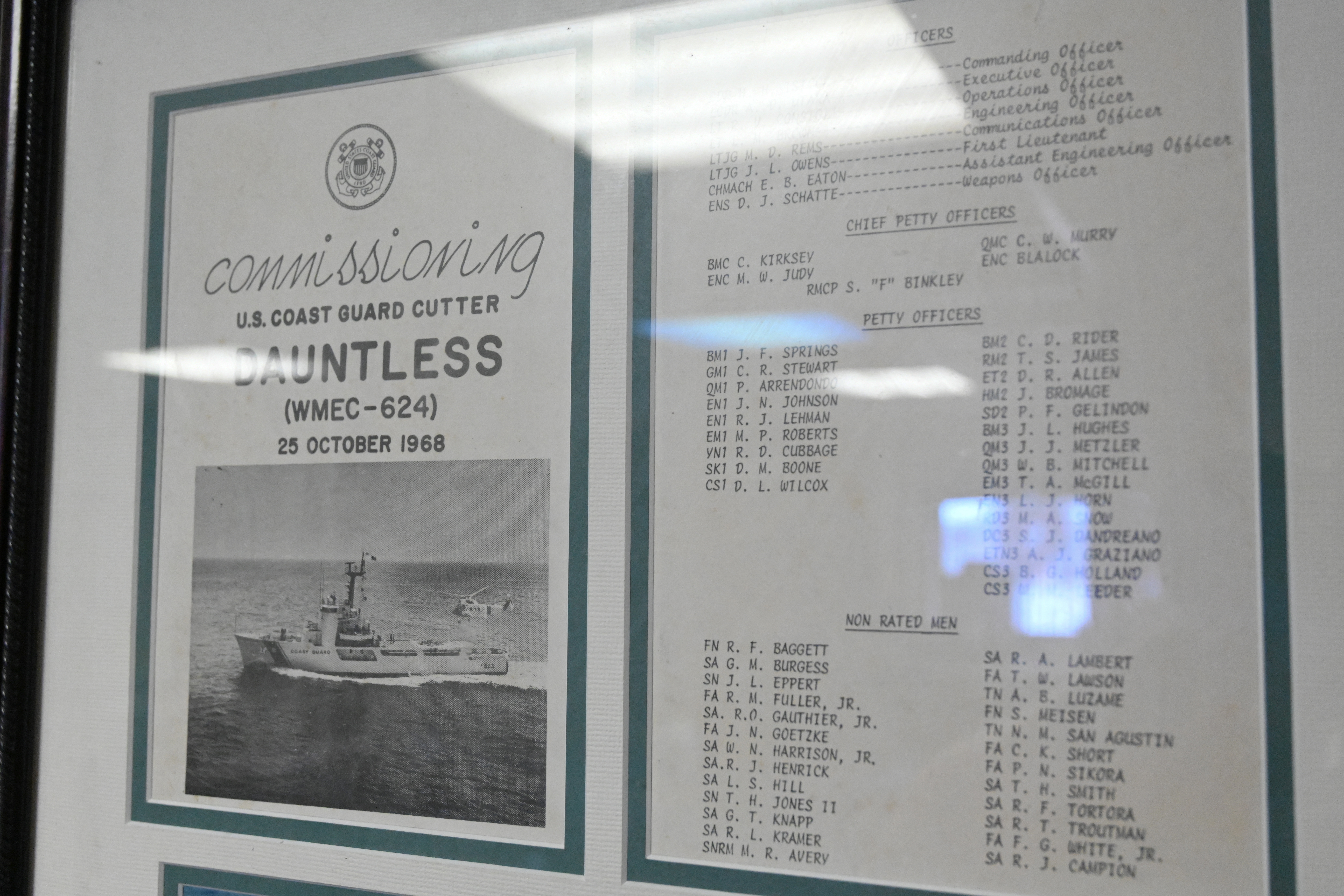 Framed memorabilia from U.S. Coast Guard Cutter Dauntless' (WMEC 624) 1968 commissioning is displayed aboard the cutter, June 21, 2024, while moored in Pensacola, Florida. Dauntless was recognized after 56 years of service to the nation during a heritage recognition ceremony in the presence of current and former crew members, family, and friends before it was placed in commission, special status. (U.S. Coast Guard photo by Petty Officer 2nd Class Brandon Hillard) Framed memorabilia from U.S. Coast Guard Cutter Dauntless' (WMEC 624) 1968 commissioning is displayed aboard the cutter, June 21, 2024, while moored in Pensacola, Florida. Dauntless was recognized after 56 years of service to the nation during a heritage recognition ceremony in the presence of current and former crew members, family, and friends before it was placed in commission, special status. (U.S. Coast Guard photo by Petty Officer 2nd Class Brandon Hillard)