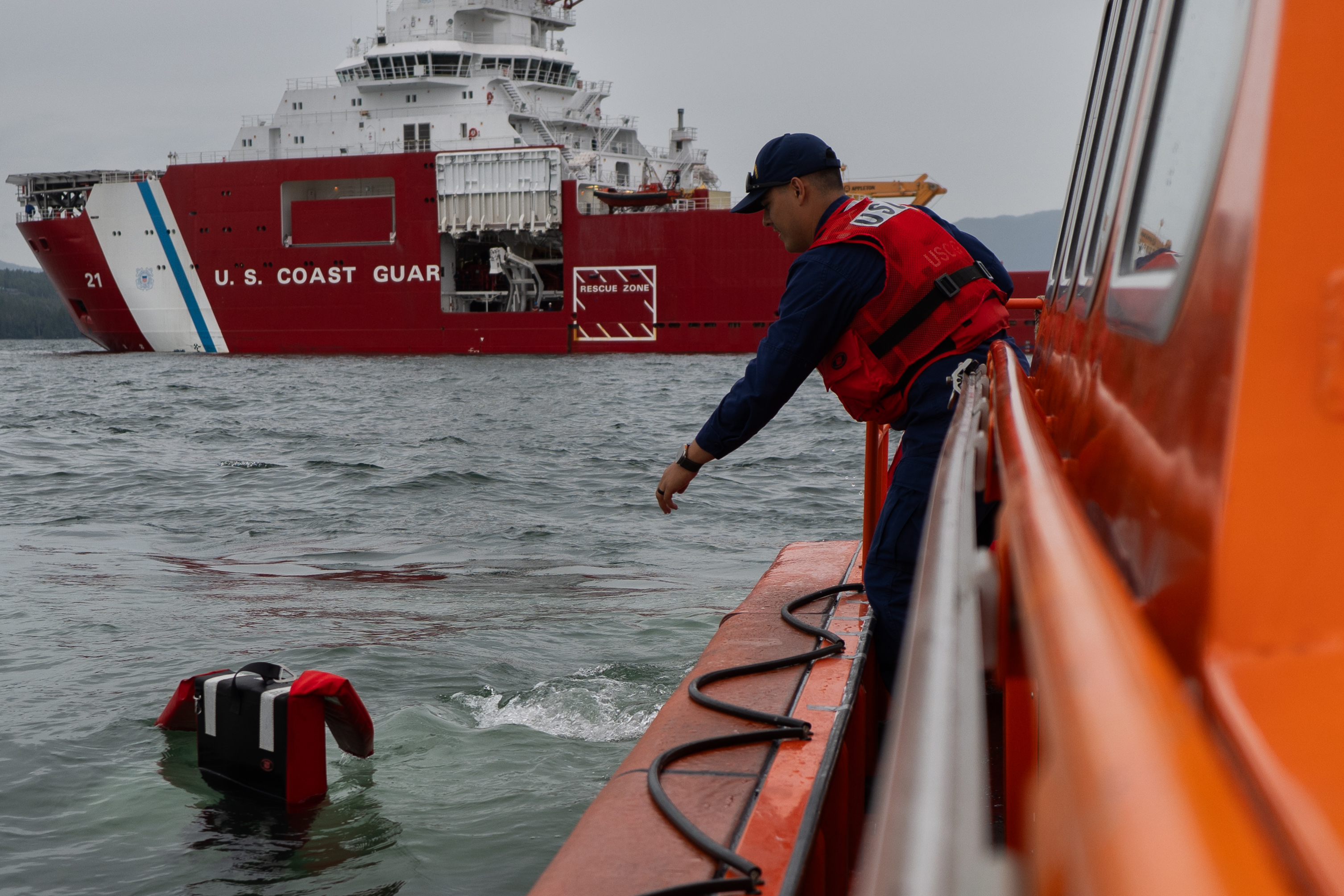 Petty Officer 2nd Class Alex Espinoza reaches for “Oscar” during a person-overboard drill aboard the U.S. Coast Guard Cutter Storis’ daughter craft on July 28, 2025. These drills ensure personnel stay operationally prepared and are ready to respond quickly to emergencies. (U.S. Coast Guard photo by Petty Officer 3rd Class Ashly Murphy) Petty Officer 2nd Class Alex Espinoza reaches for “Oscar” during a person-overboard drill aboard the U.S. Coast Guard Cutter Storis’ daughter craft on July 28, 2025. These drills ensure personnel stay operationally prepared and are ready to respond quickly to emergencies. (U.S. Coast Guard photo by Petty Officer 3rd Class Ashly Murphy)
