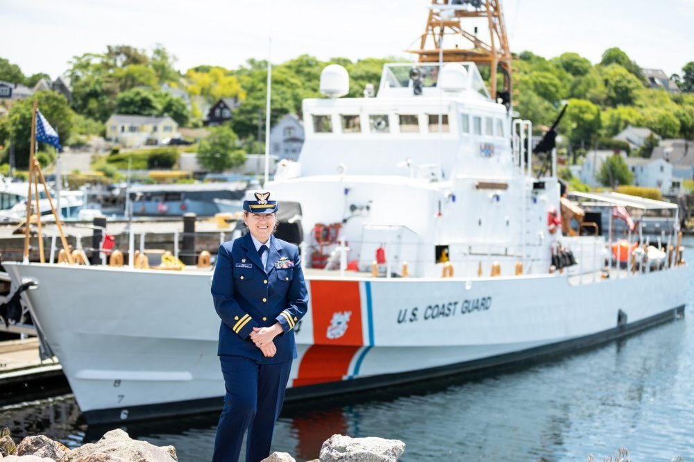 Lt. Tara Pray stands in front of U.S. Coast Guard Cutter Key Largo Largo homeported in historic Gloucester, Massachusetts. (U.S. Coast Guard Photo)