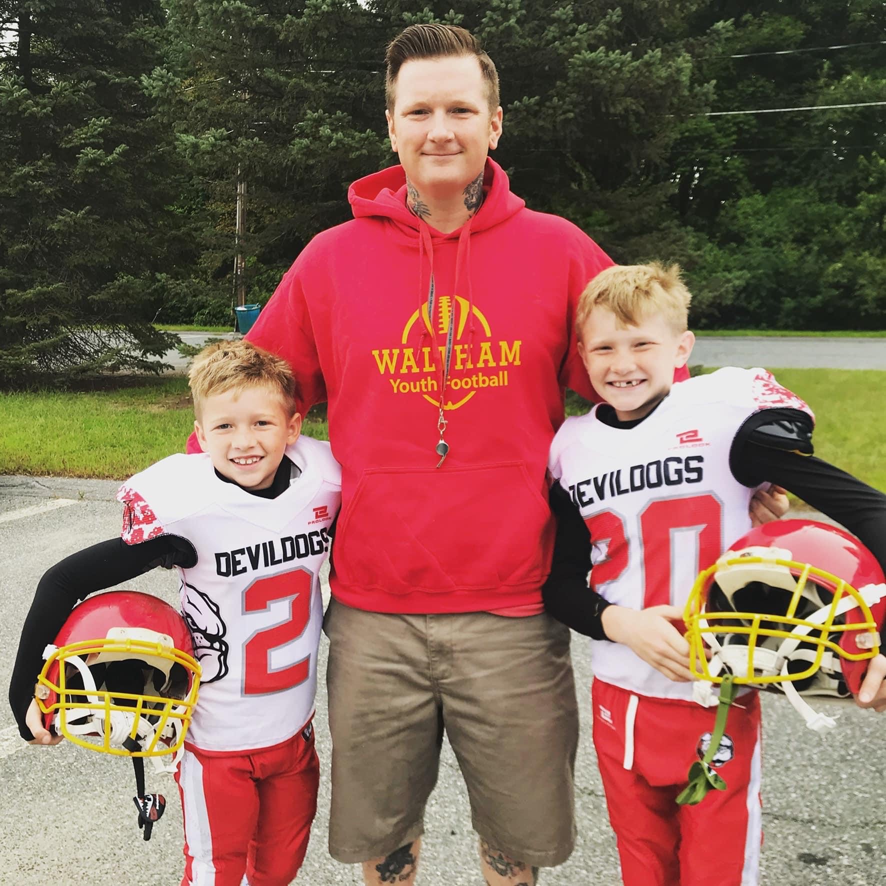 Coast Guard spouse, Justin Oldham, is pictured with his two sons (left to right) Tatum and Bodie after a game of football through the Waltham Youth Football program. 