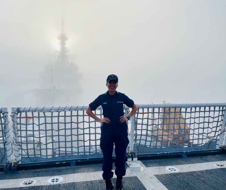 Lt. Jalle Merritt, a combat systems officer assigned to the Coast Guard Cutter Waesche, photographed with a national security cutter in the background. Merritt is slated to command the Coast Guard Cutter Myrtle Hazard in July 2022. 