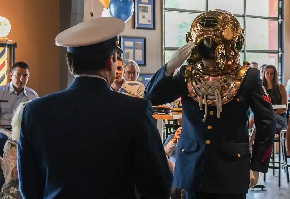 Coast Guard members hold a retirement ceremony for a chief petty officer in Chesapeake, Virginia, July 08, 2022. The chief served as a Coast Guard diver, who are experts in subsurface operations. (U.S. Coast Guard photo by Michael R. Moberley)