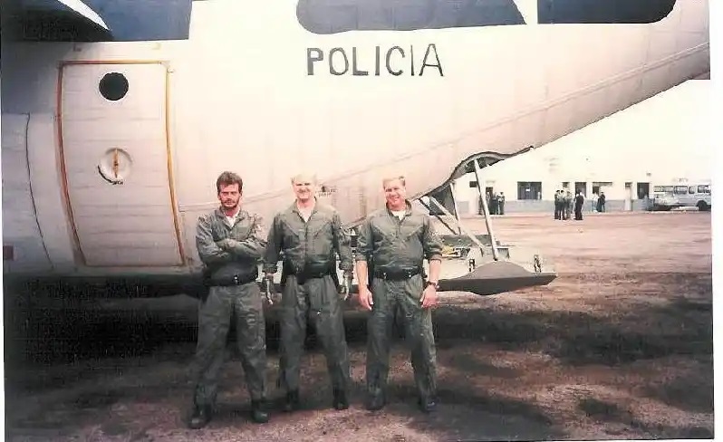 Coast Guardsmen Petty Officers Second Class Charles Vilamere and Mike Kaszuba and Petty Officer First Class Steven “Sleepy” Franks, stand in front of a Coast Guard C-130 with “Policia” markings on the fuselage. (Coast Guard Aviation Association)