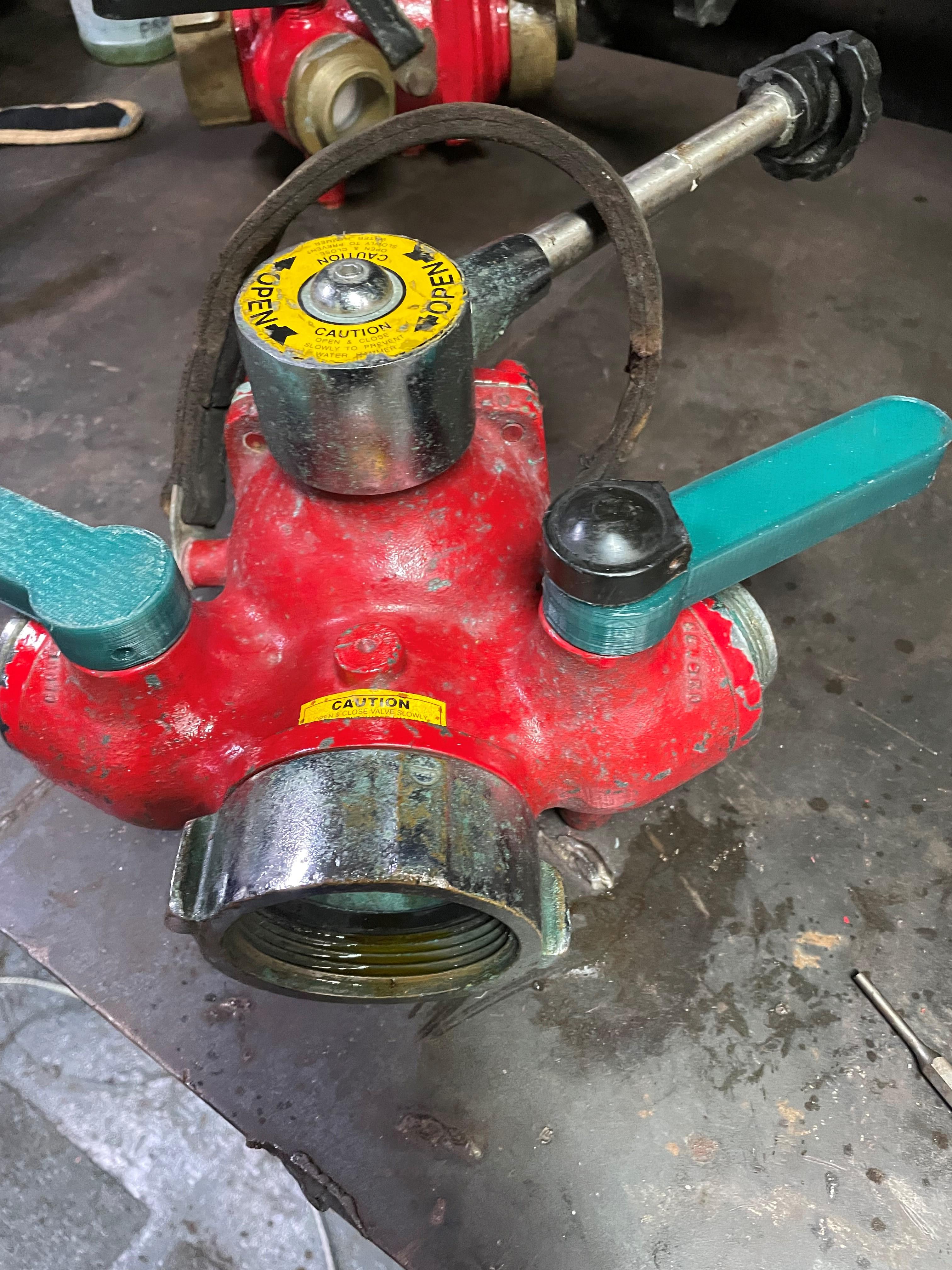 Members serving aboard the Coast Guard Cutter Venturous used a 3D printer to replace broken and cracked handles on the Y-door, which is a part that allows a fire hydrant to feed two separate hoses.  The handles are used to direct the flow of water.  (US Coast Guard photo.) 