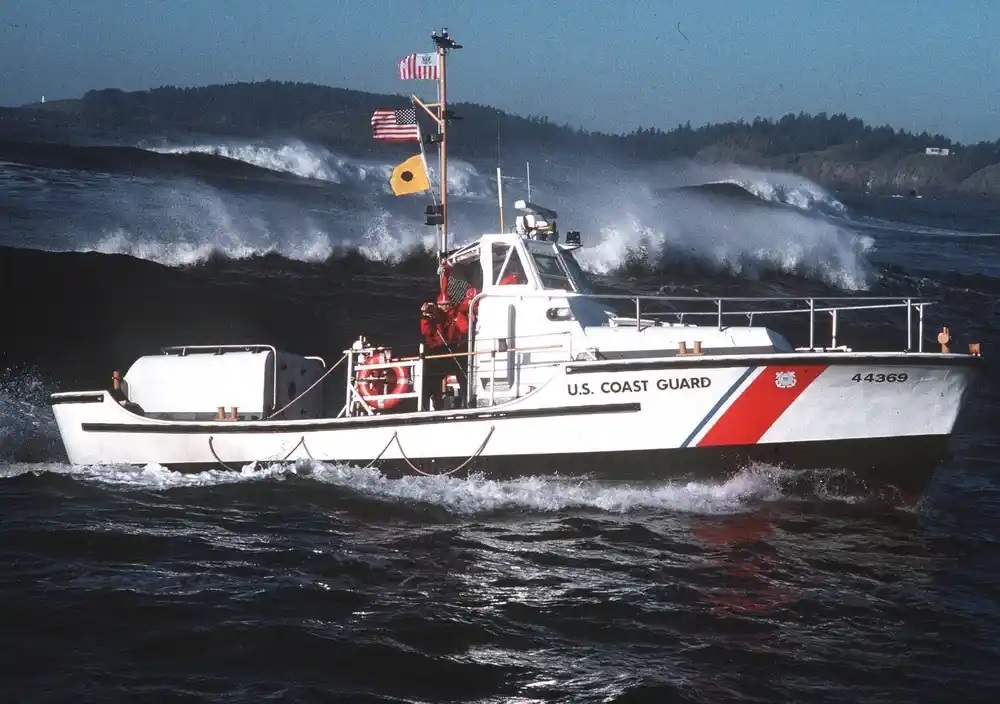 A Coast Guard self-righting 44-foot motor lifeboat underway in the breaking surf of the West Coast. (U.S. Coast Guard)