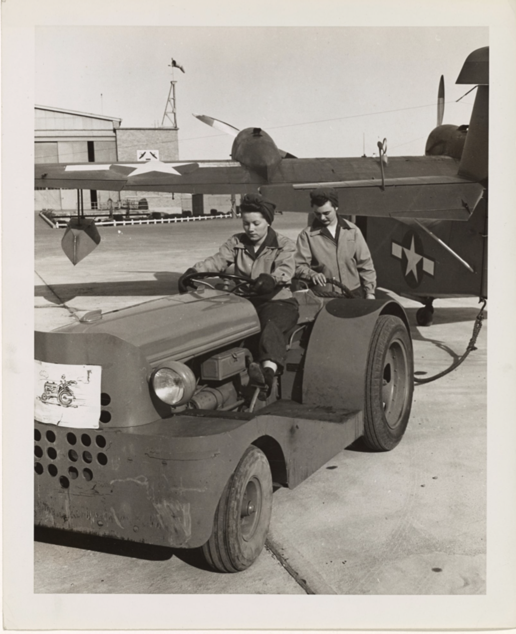 SPAR aviation mechanic Marian Behrends preparing to tow a Coast Guard amphibian aircraft back to the hangar. (National Archives)