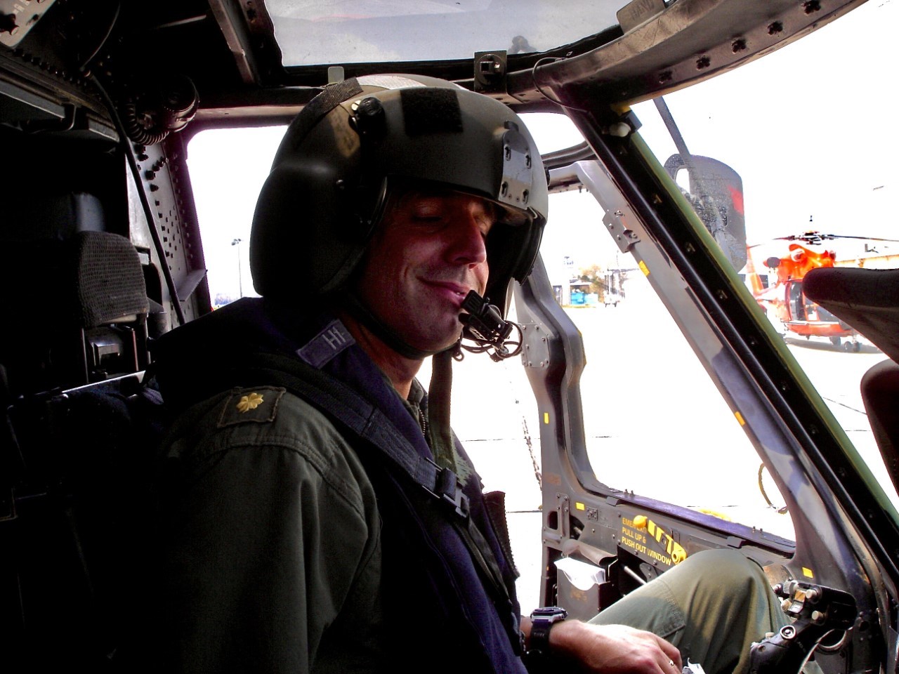 Cockpit photo of Lt. Cmdr. Jim O’Keefe at the controls of a Coast Guard HH-60J helicopter. (Photograph courtesy of James O’Keefe)
