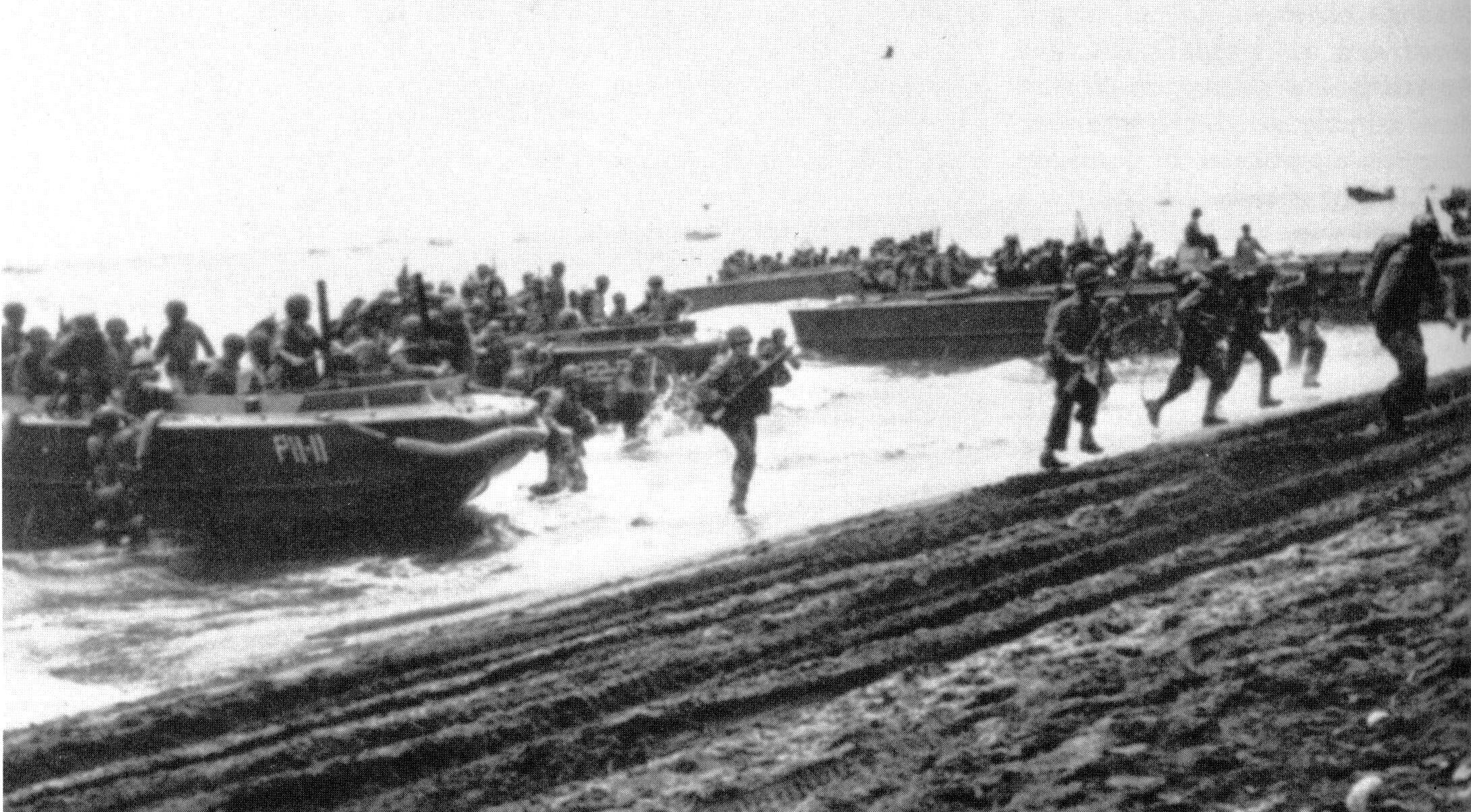 A faded image of Marines landing on Guadalcanal Aug 7, 1942. The Marines landing on Guadalcanal far outnumbered the unprepared Japanese troops and civilian airfield workers on the island, so the enemy fled for the cover of Guadalcanal’s jungle interior. (Courtesy of the U.S. Navy)