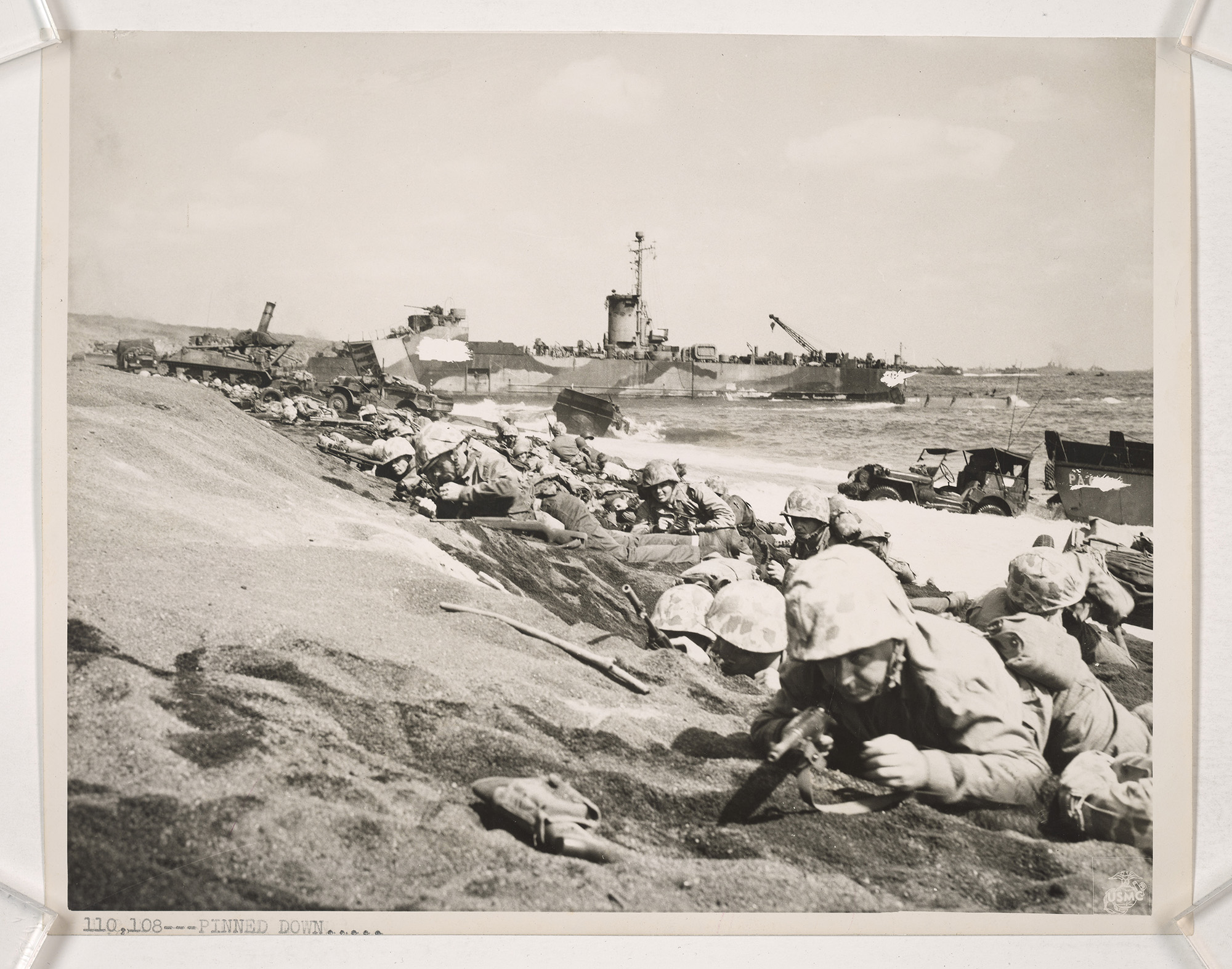 Marines pinned down by enemy fire on the landing beaches of Iwo Jima. (National Archives) Marines pinned down by enemy fire on the landing beaches of Iwo Jima. (National Archives)
