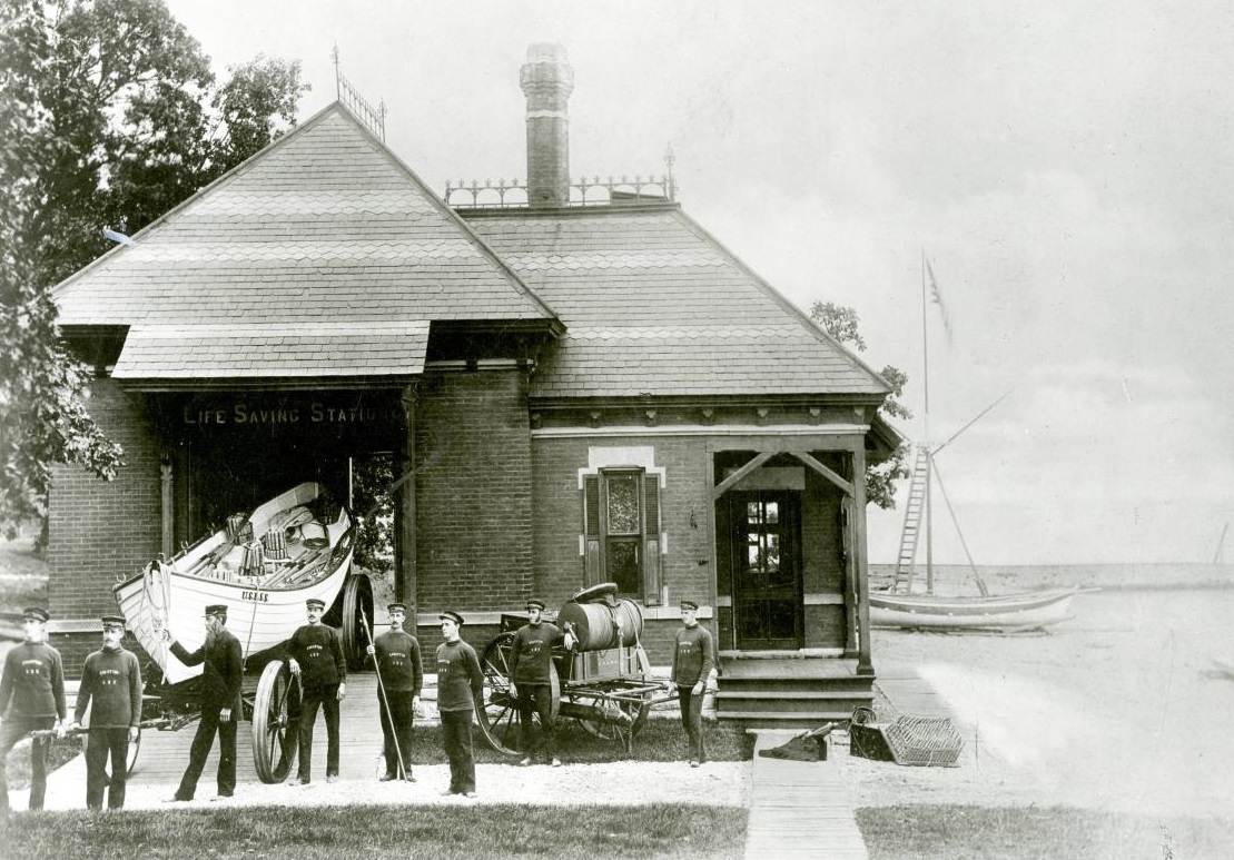 Period photograph of the Parkinson-designed 1877 station building, with the station’s Beebe type pulling surfboat on its boat wagon at left, and the beach cart at center. Keeper Lawson can be seen at the front of the surfboat. (Courtesy of NWU Deering Library)
