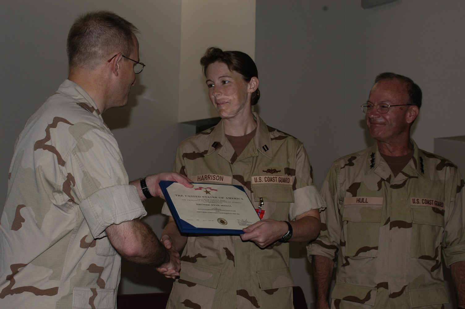 5.	Lt. Holly Harrison receiving the Bronze Star Medal with Atlantic Area Commander Vice Adm. James Hull looking on. (Coast Guard Collection)