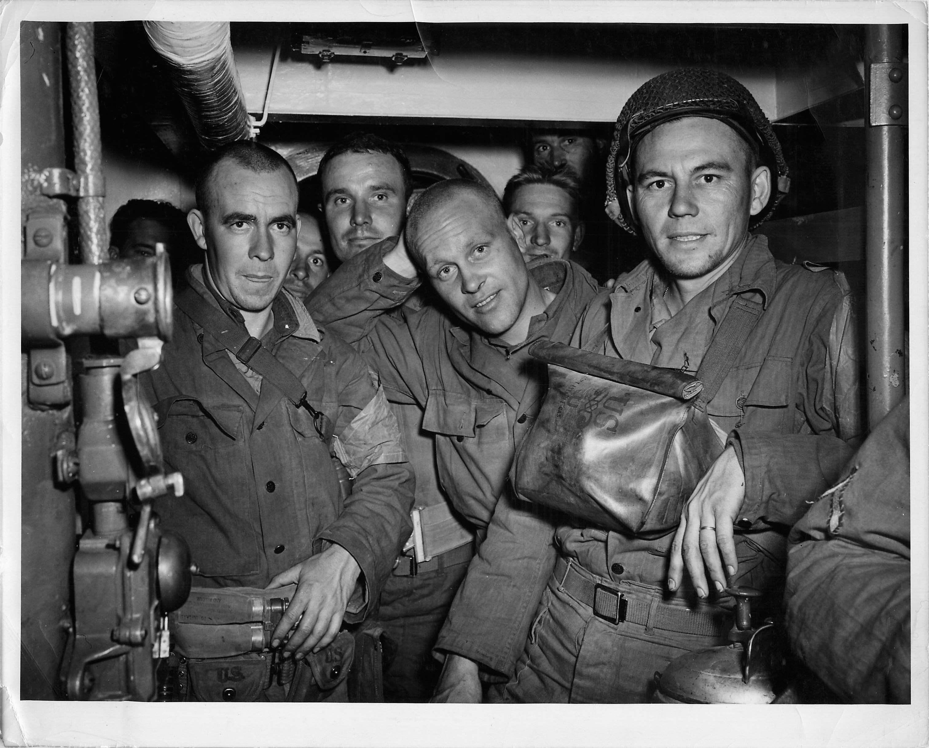 Photo of soldiers in a cramped troop compartment of a Coast Guard-manned LCI. (U.S. Coast Guard)
