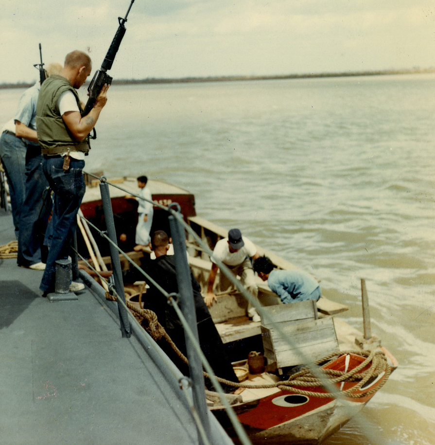 3)	Coast Guard personnel from an 82-footer inspecting a junk boat on the Saigon River. (U.S. Coast Guard)