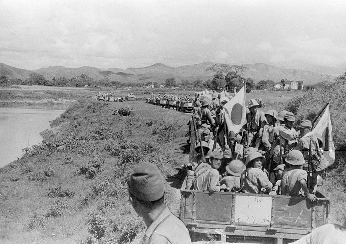 Japanese Imperial Army soldiers advance to Lang Son, in September 1940 in French Indochina--note the rifle-attached hinomaru yosegaki on the right (Wikimedia.org).