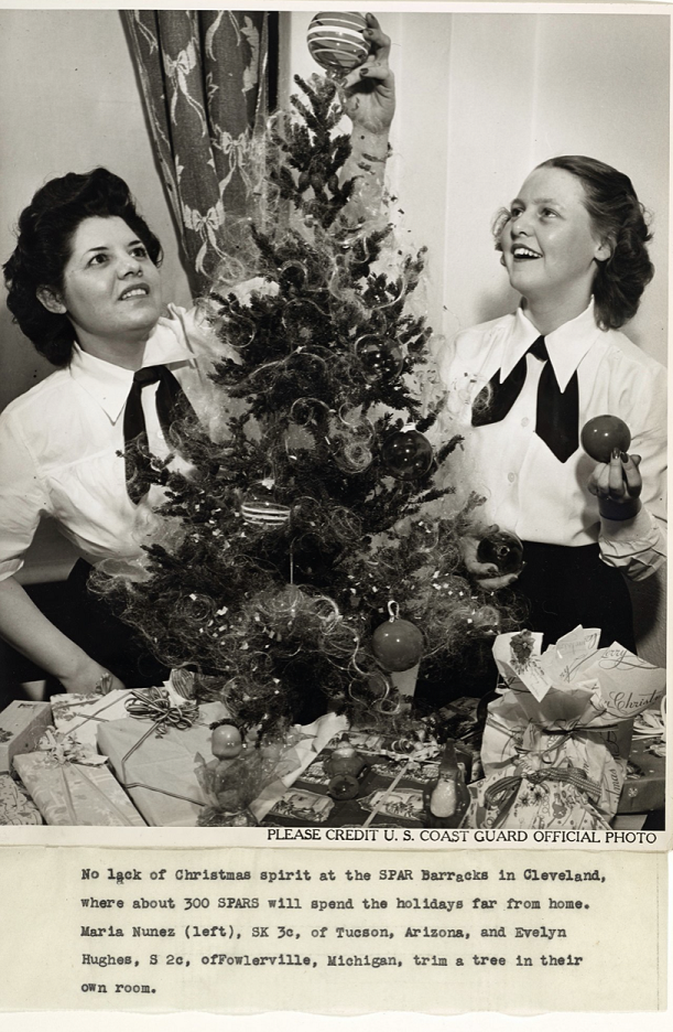 3)	Christmas photograph showing Storekeeper third Class Maria Nunez serving the Holidays in Cleveland with 300 other SPARs. (U.S. Coast Guard)