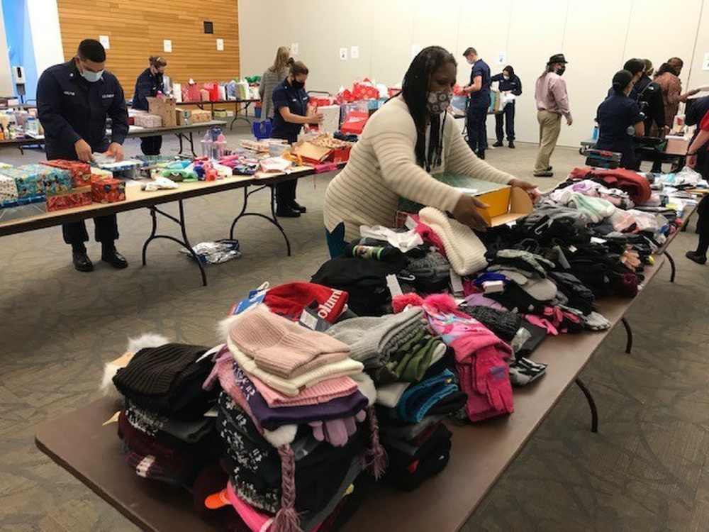 Members of Headquarters, Base National Capital Region, and Department of Homeland Security gathered to pack gift bags and personal care item kits for communities neighboring the Douglas Munro Coast Guard Headquarters, in Washington, D.C., Dec. 16, 2020. Donated items were distributed through partners in the District of Columbia Housing Authority Ward 8 community and to the So That Others Might Eat (SOME) non-profit. An annual event at Base NCR, the holiday gift drive is one of two volunteer events, followed by a back-pack school supply drive that takes place each summer. Numerous volunteers sorted, packed and loaded the items for distribution. (U.S. Coast Guard Photo)