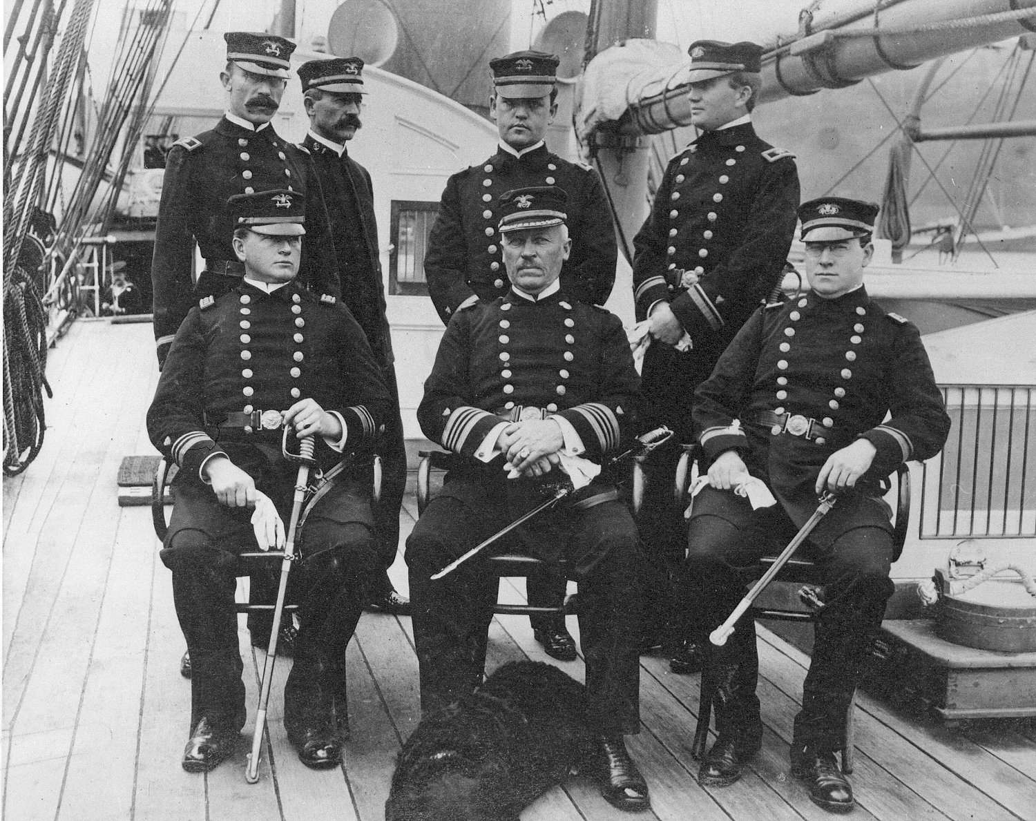 Photograph of Capt. Oscar Hamlet with officers of Revenue Cutter Thetis with ship’s mascot at his feet. (U.S. Coast Guard)