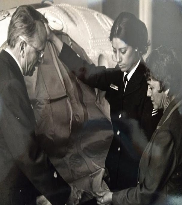 4.	Petty Officer 3rd class Dior Lowen, shows her parents an HH-52 helicopter, the airframe she flew in as an aviation survivalman. (U.S. Coast Guard)