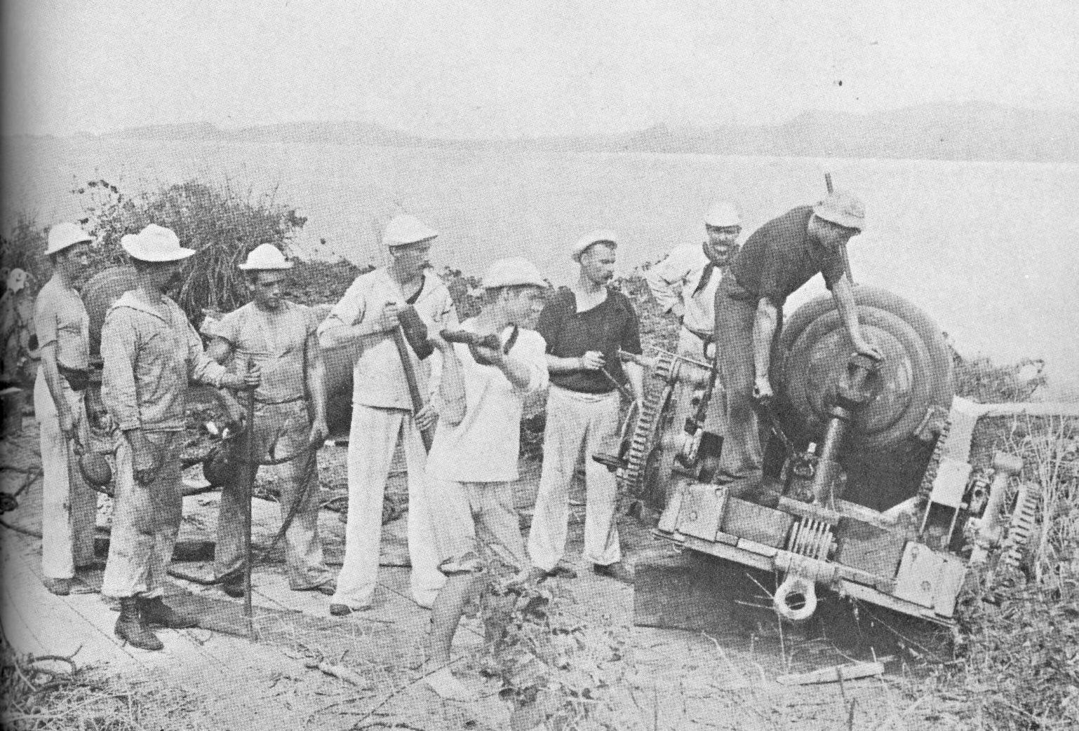 Members of Revenue Cutter McCulloch’s crew pose with a Spanish shore gun disabled during Battle of Manila Bay. (Courtesy of U.S. Navy)