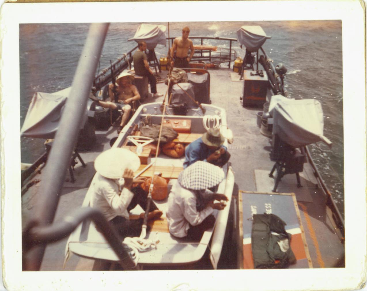 4)	Fantail of an 82-foot patrol boat with Vietcong detainees seated in the  Boston Whaler-style smallboat. (Courtesy of Gordon M. Gillies)