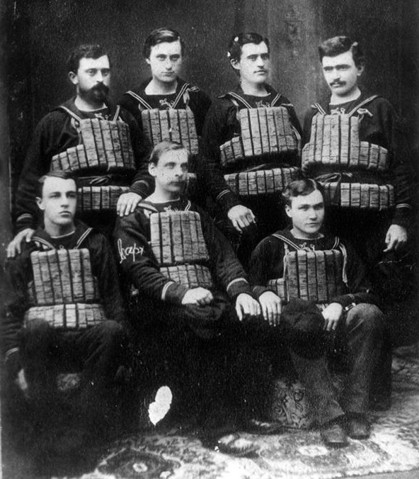 1877 photograph of the NWU student surfman crew, wearing the uniforms in use at that time along with their cork life jackets; the student names were recorded as, back row left to right: W.E. King, C.E. Piper, M.J. Hall, W.A. Shannon; front row left to right: W.T. Hobart, E.J. Bicknell and T. C. Warrington. (Courtesy of NWU Deering Library)