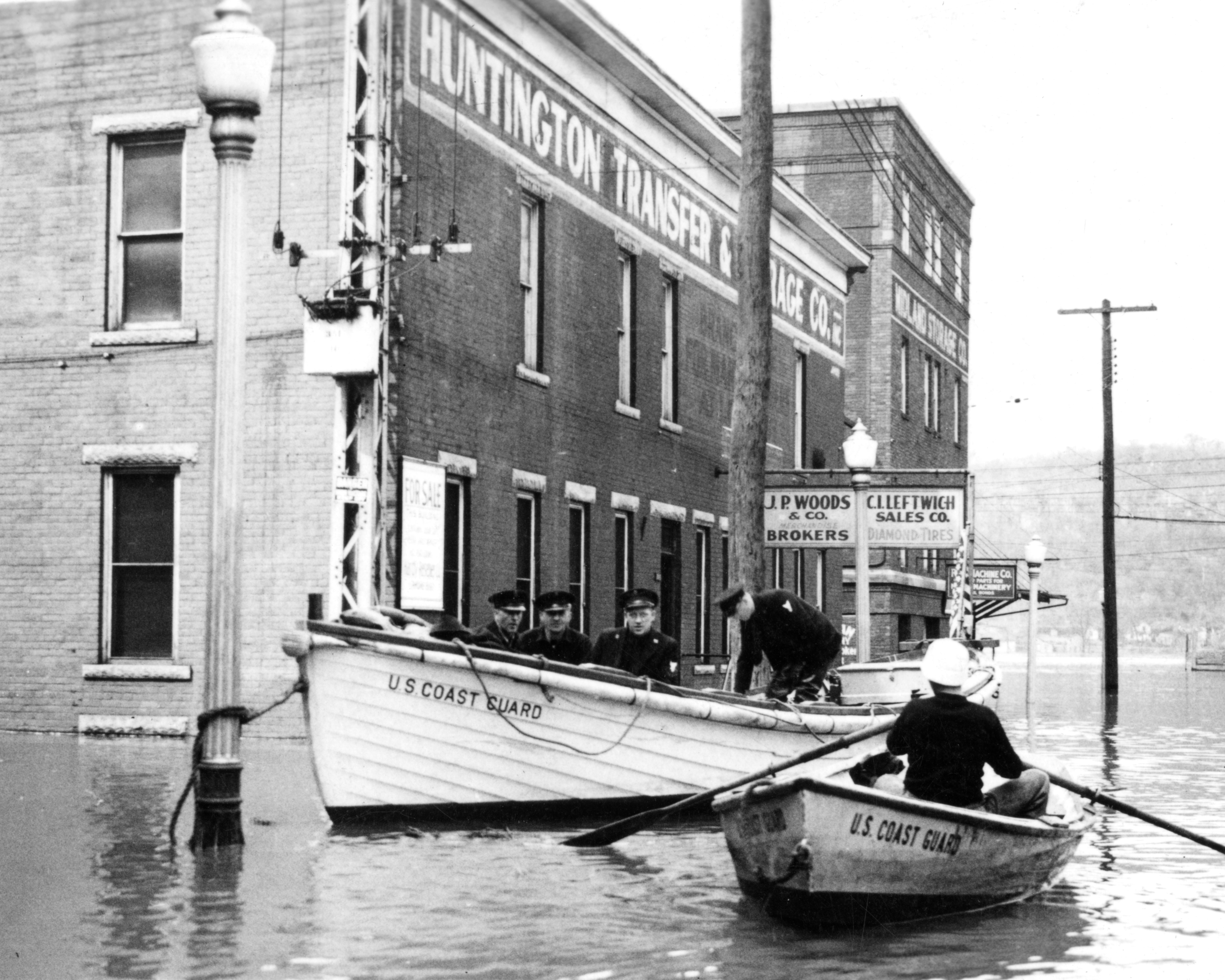 5.	Coast Guardsmen set up floating command post tied to a lamppost and dispatch personnel by dinghy to the flooded town. (U.S. Coast Guard)