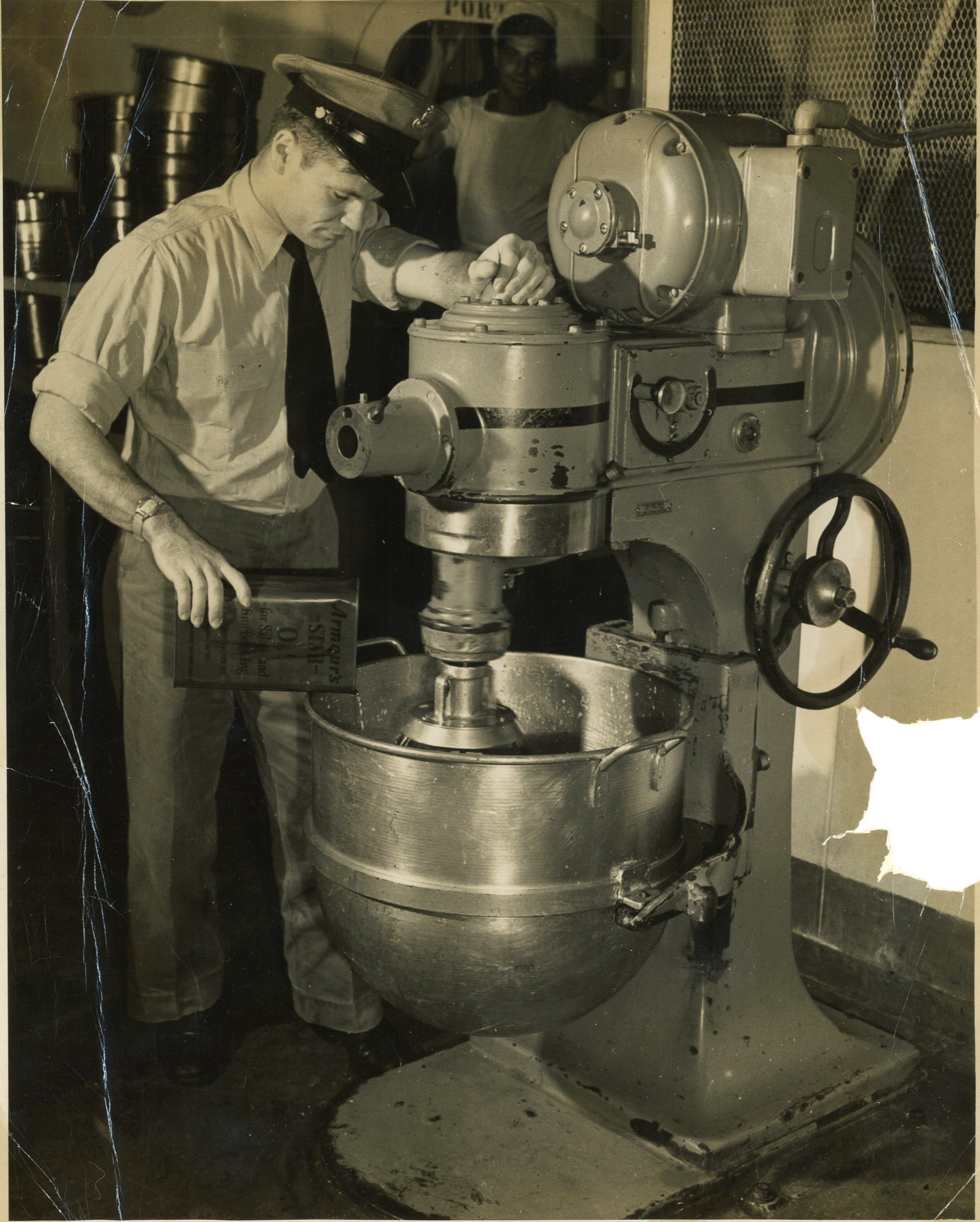 Chief Commissaryman Robert Manges at work preparing food for the thousands of troops taking passage on board troop transport Wakefield. (Courtesy of Robert Manges)