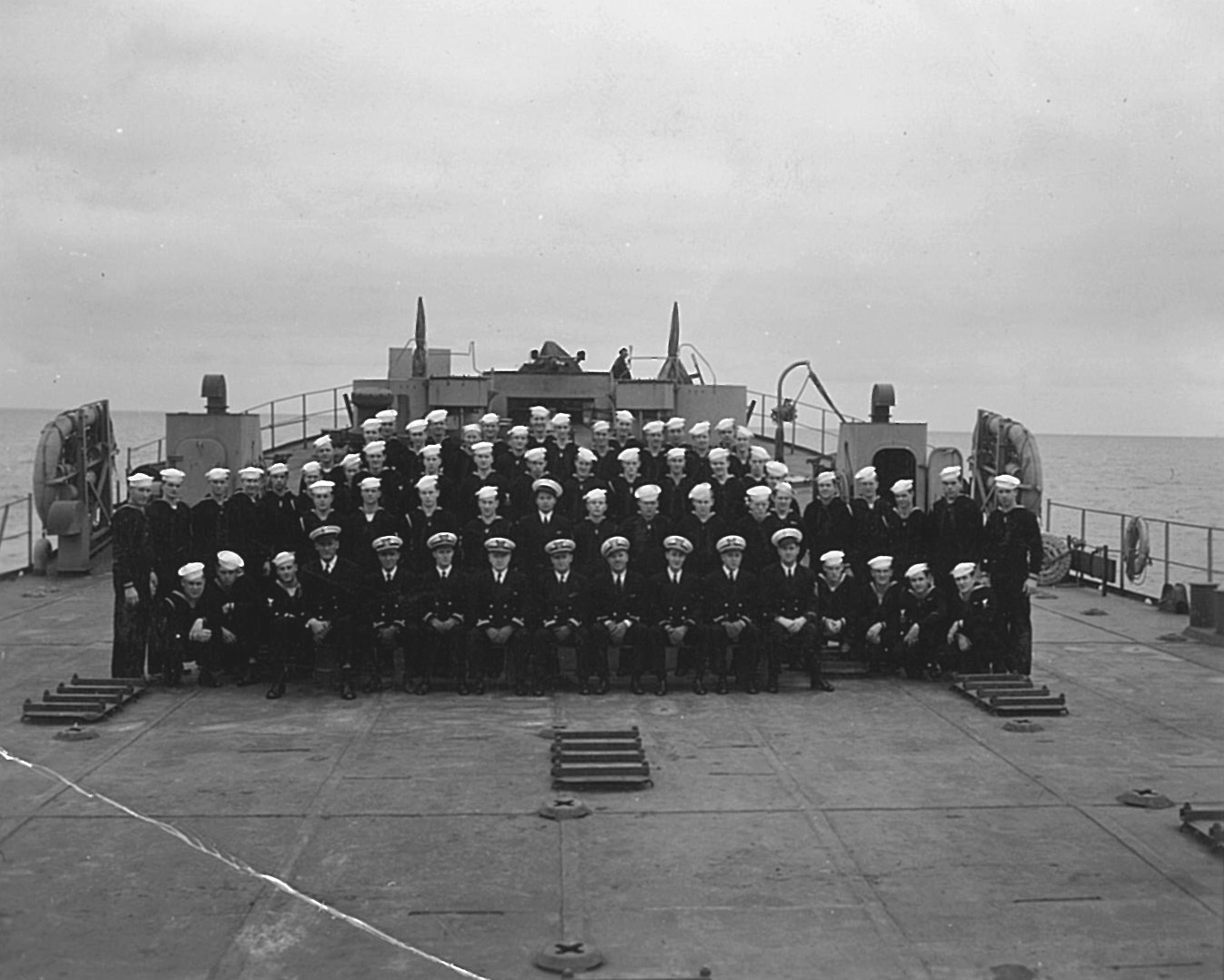 5)	Crew photograph for LST 20. Joe Tezanos stands tall second from the right in the second row. (Courtesy of the Tezanos Family)