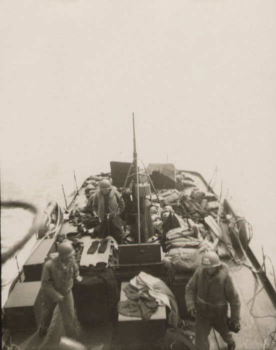 CG-16 crewmembers in combat helmets on D-Day with one man standing by at the stern-mounted 20-millimeter anti-aircraft gun. (Courtesy of Hannigan family)