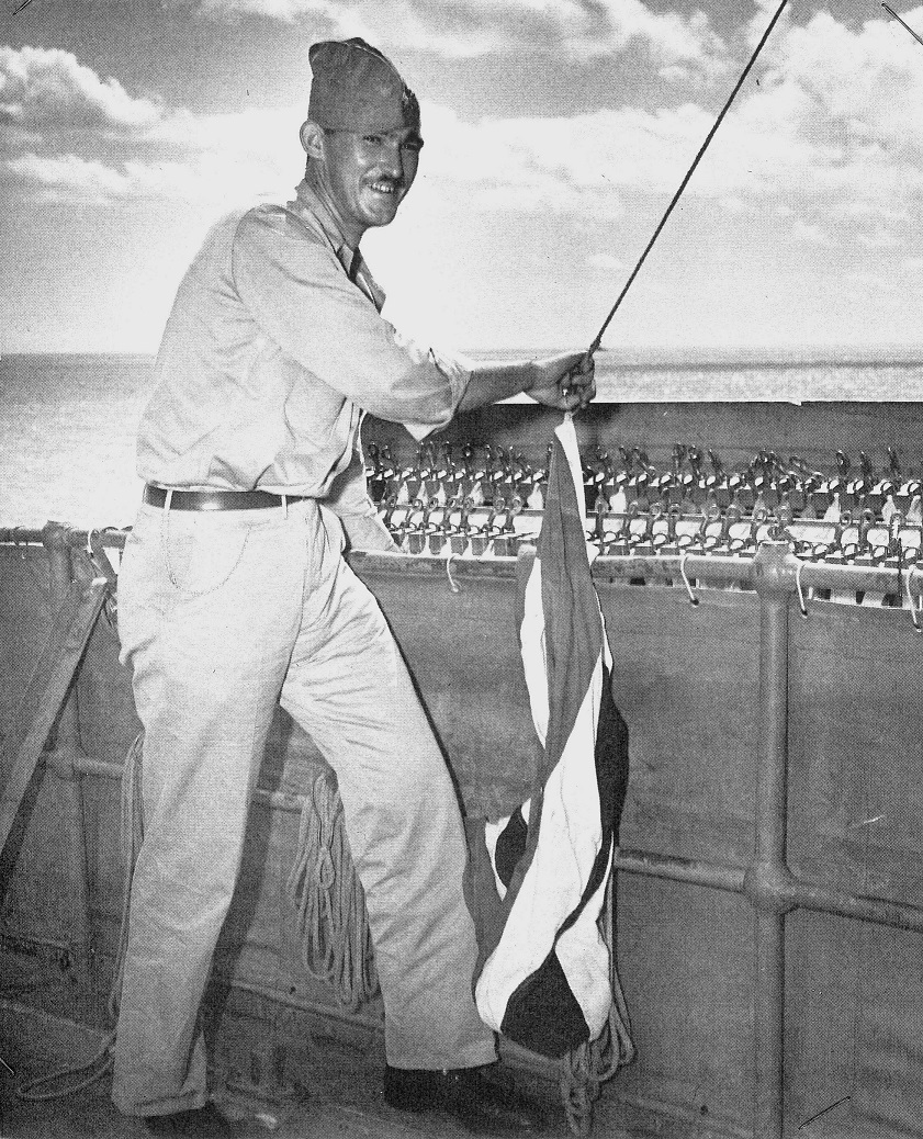 6.	Chief Signalman Ray Evans working the signal flags on the bridge deck of a Coast Guard-manned vessel in 1943. (Coast Guard Collection)