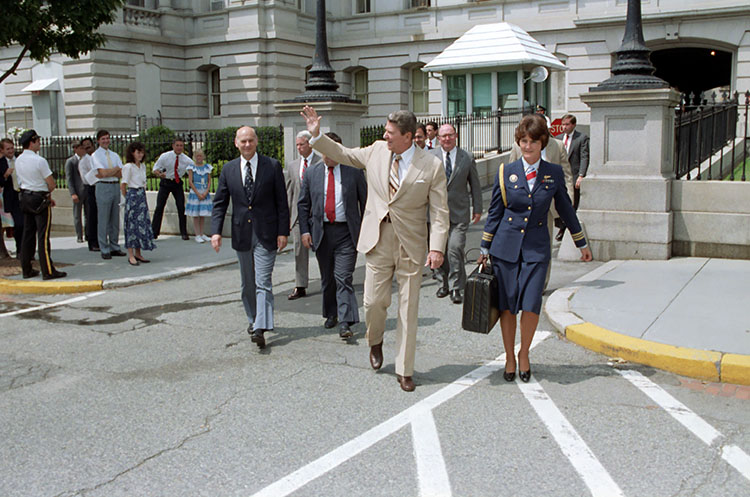 Lt. Cmdr. Crea walking beside President Ronald Reagan while handcuffed to the “Nuclear Football” briefcase. (Courtesy of the Ronald Reagan Presidential Library)