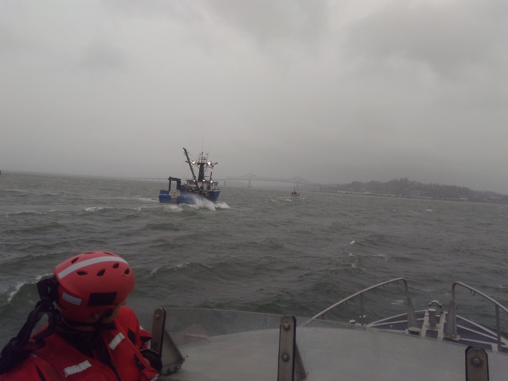 Steel-hulled Triumph II towing a disabled fishing vessel in heavy weather. (U.S. Coast Guard)